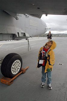 Arlington’s Diego Rivera inspects the underside of an FA-18 on the USS Abraham Lincoln flight deck April 1.