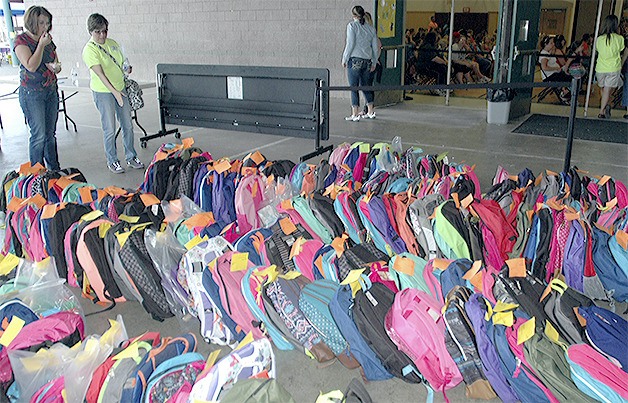 Hundreds of colorful backpacks await children in need at the Arlington Back2School event Sunday