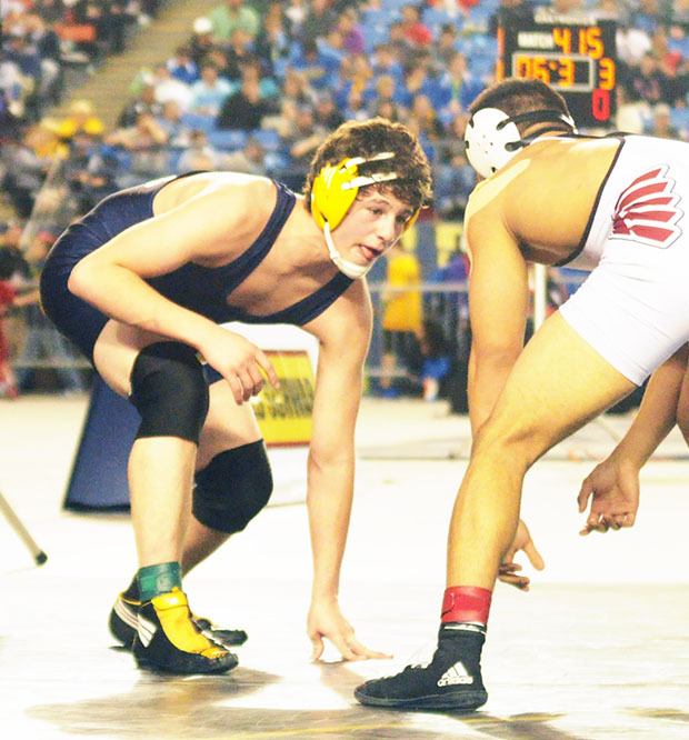 Arlington junior Ruben Crew squares off against North Central's Izaec Quintanilla during the 3A state finals at the Tacoma Dome Feb. 21.