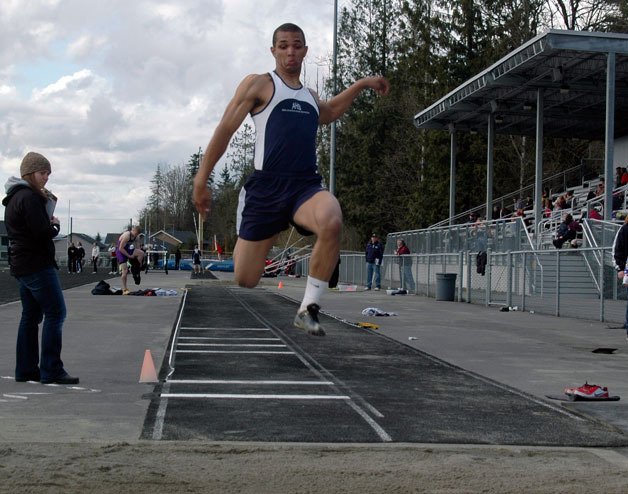 Arlington’s Lucas Revelle launches himself into the long jump on April 21.