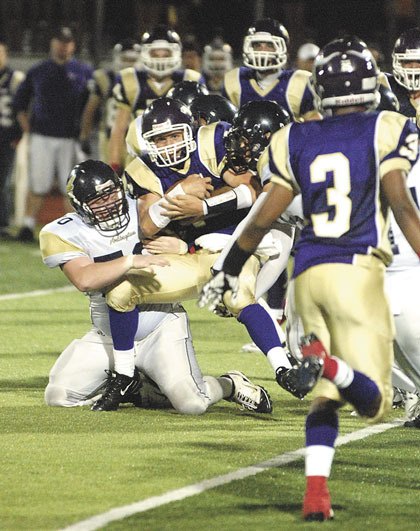 Arlington defensive lineman Dylan Worley brings down Lake Stevens halfback Duke Dolphin.