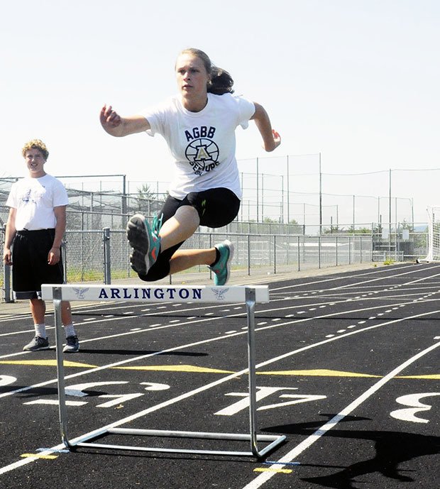 Jessica Ludwig goes over a hurdle in practice before her meet in state.
