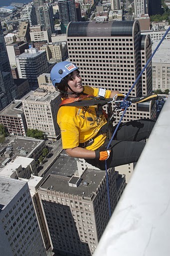 Arlington Eagles Special Olympics Team Coach Sandy Catiis begins climb down the Rainier Tower in Seattle for last year's 'Over the Edge' fundraiser.