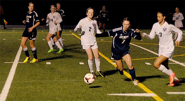 Alison Enell (blue) of Arlington pursues the ball.