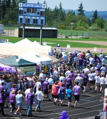 Participants in the 2011 Arlington Relay For Life complete their final lap at the Arlington High School track and field on June 5.