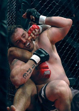 Arlington mixed martial arts fighter Matt “The Attack” Kovacs gets tangled up against the cage with opponent Nick Braker.