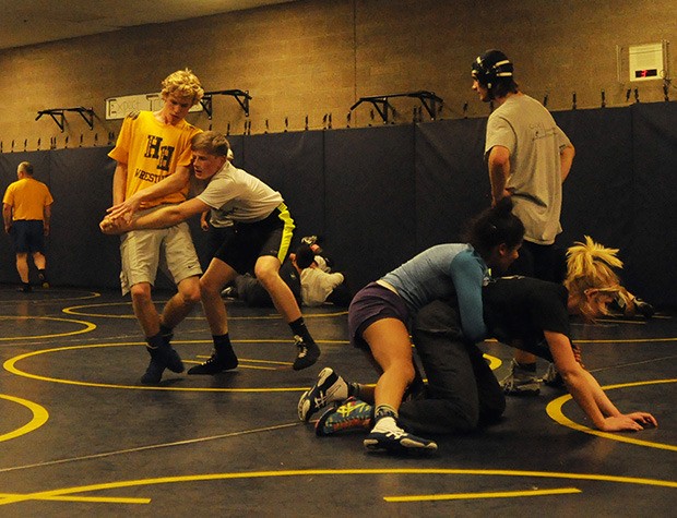 Arlington wrestlers practice their techniques before the start of the season.