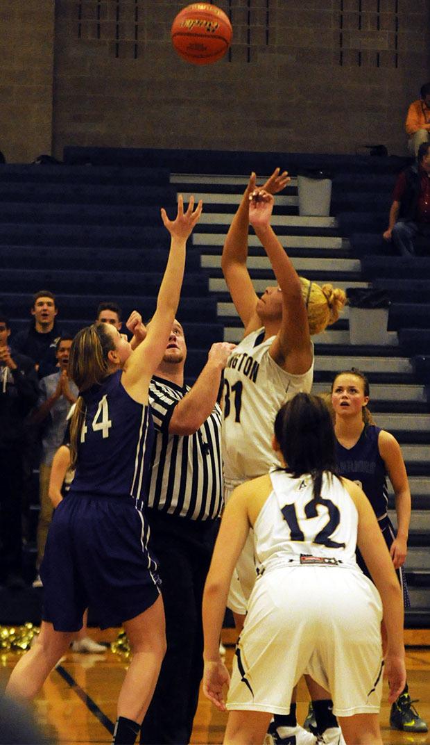 Arlington's Jayla Russ leaps up for tip off into overtime.