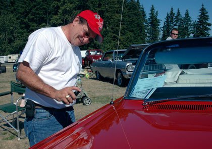 Yakima Resident Danny Pellegrini cleans his 1964 Pontiac Bonneville during last year’s Arlington Drag Strip Reunion and Car Show. This year’s event is taking place Sept. 11.