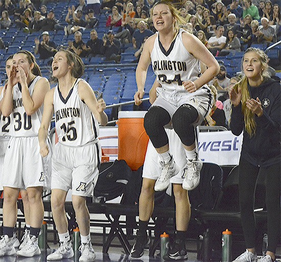 The Arlington Eagles bench jumps for joy as it pulls away from Kamiakin March 4