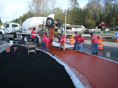 Crews pour the red concrete in the truck apron around the center of the roundabout at the intersection of state routes 9 and 531 on Nov. 5.
