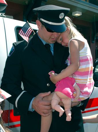 Arlington firefighter Jason Abrahamson holds his daughter Kara