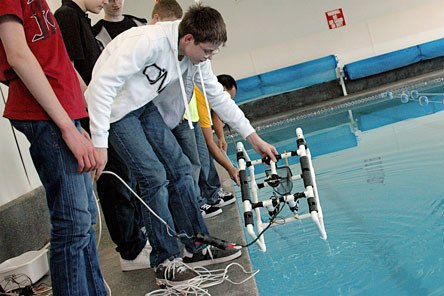 Haller Middle School student Tyler Hering lifts his teamâ€™s remote controlled submersible out of the Stillaguamish Athletic Club pool on Friday