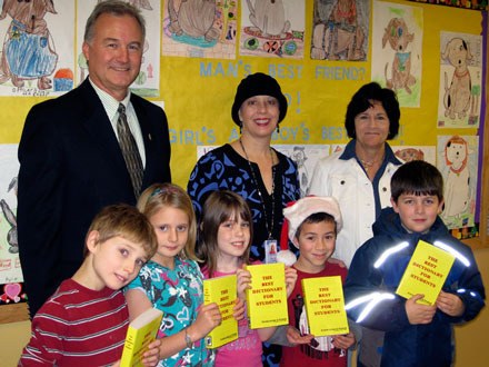 Members of the Arlington Kiwanis Club and the Friends of the Arlington Library present new dictionaries to third-grade students at Presidents Elementary Dec. 9. Back row