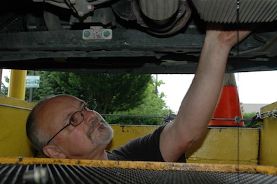 Vince Willett conducts a routine oil change in one of the three service bays at the Mr. Buckles Oil Change Service Center in Smokey Point.