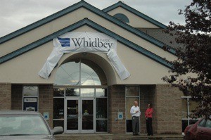 A temporary Whidbey Island Bank sign hangs from the former Smokey Point branch of North County Bank on Monday