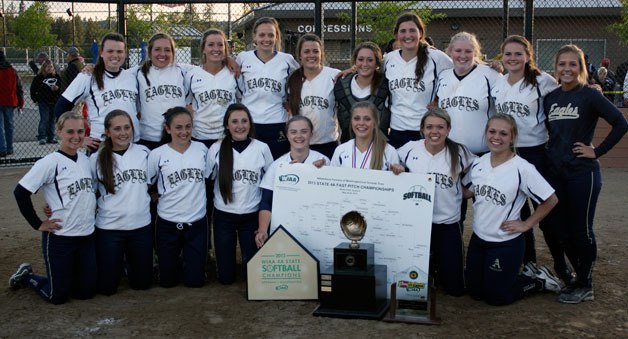 Arlington High School’s fast-pitch softball team poses with its awards and trophy after winning its first state championship ever on May 25