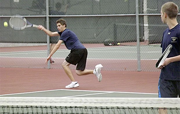 Connor Ghirardo of Arlington returns a serve during the Eagles match against Everett Oct. 13. The home team lost to the Eagles 4-0. All of the matches were not finished because of rain. Connor and doubles teammate Jesse Vaughan actually were leading their match.