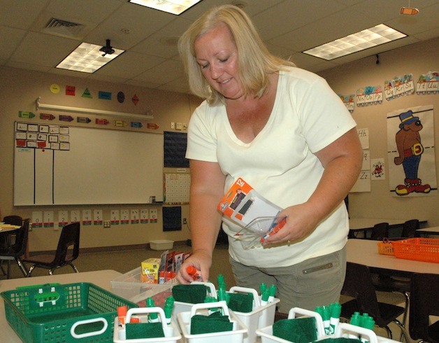 Pioneer Elementary kindergarten teacher Julie Delaney gets her classroom ready for the first day of school Sept. 3.