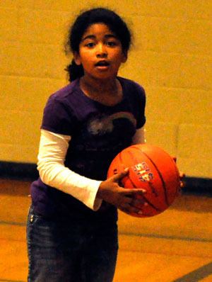 Enija Reed practices her basketball skills at the Arlington Boys & Girls Club on July 3.