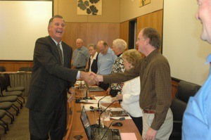 New Arlington Police Chief Nelson Beazley smiles as he shakes hands with City Council member Chris Raezer on Sept. 7.