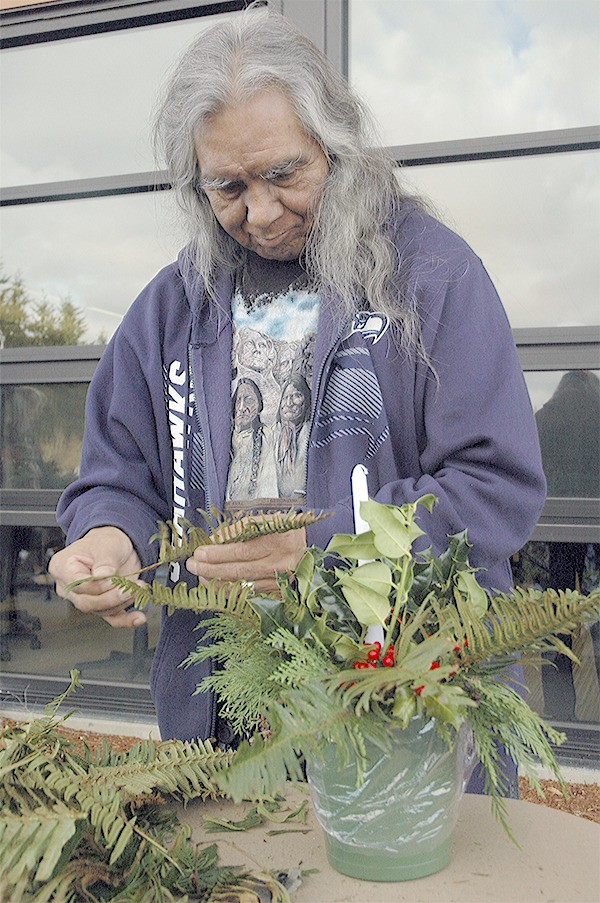 Louie Michelle puts together a decoration at the Tulalip event Dec. 13.