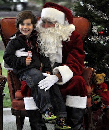 Finnegan Bowman smiled as he told Santa Claus his Christmas toy wish list during last year's Hometown Holidays in downtown Arlington.