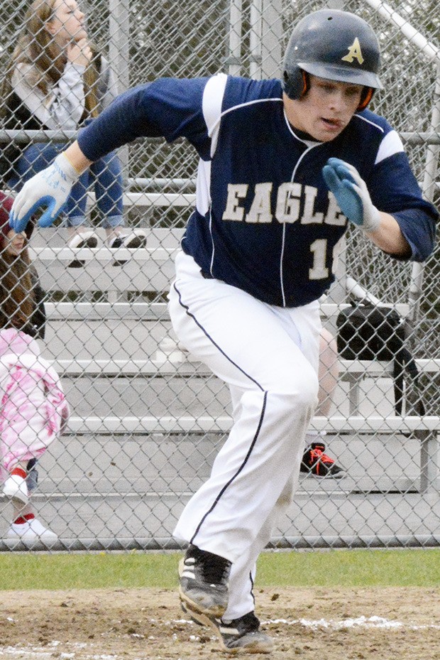 An Arlington baseball player takes off after a hit.