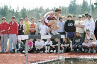 Lakewood senior Miles Rossow clears a water hurdle in the 2k steplechase