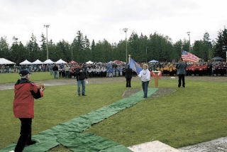 Arlington Mayor Margaret Larson throws out the first pitch on the newly rededicated Quake Field.