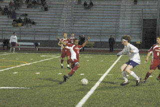 M-P sophomore John Crenshaw goes in for the ball.