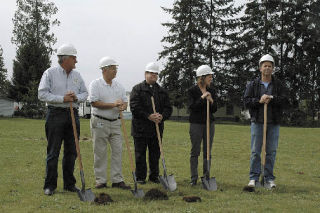 Trying to move at least a little earth during a groundbreaking ceremony for the new Marysville Food Bank are