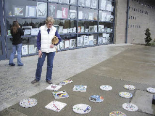 Norma Bailey views hand-crafted pavers at the Arlington High School Arts Festival Saturday