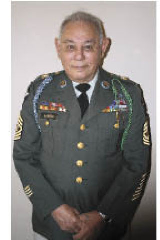 Eliseo Garcia still fits into his military dress uniform. He enlisted in the Army at the age of 15