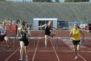 Junior Amanda Wregglesworth jumps in the girls 300 hurdles.