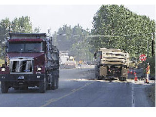 Gravel trucks buzz up and down SR 9 north of Arlington Monday morning in the last-minute effort to open the new bridge over Harvey Creek as part of the north of Arlington SR 9 expansion project. Work will continue on the left turn lanes at Kackman Road (252nd) and the Stanwood Bryant Road (268th) to be completed this fall.