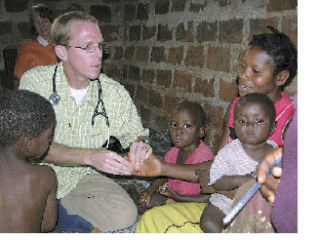 Tyler Anderson provides medical care to villagers outside of Kampala