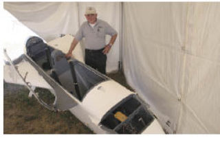 James Davison shows off the single-engine experimental aircraft that he crashed June 2 into a grassy field west of Arlington.