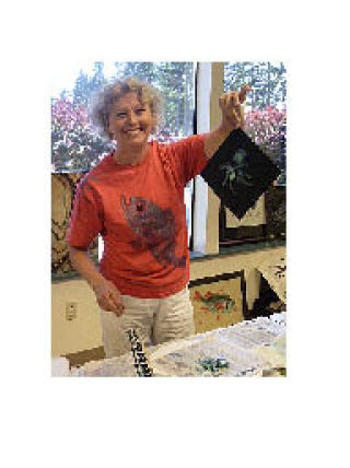 Helen Saunders demonstrates fish printing at the Arlington Arts Councilâ€™s July 8 meeting and she will be exhibiting her prints and other multimedia work at Art by the Bay