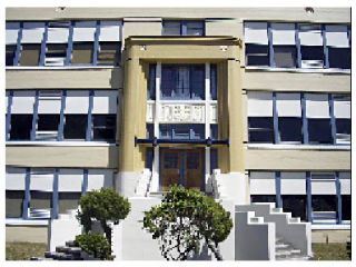 The old Arlington High School is newly painted a nice warm gold with blue trim blue