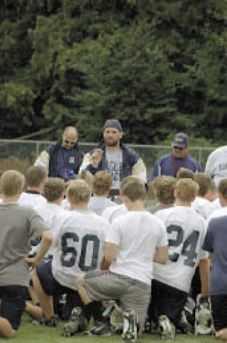 Arlington coach Greg Dailer addresses his team at the end of practice.