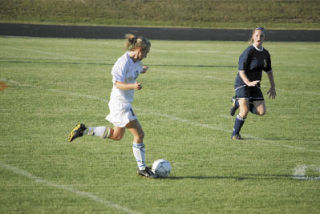 Senior defender Anna Work dribbles the ball down field against Burlington-Edison. Work is one of the team captains.