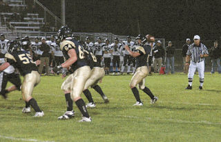 Quarterback Jake Parduhn goes through the air for one of his receivers. The junior totaled 261 passing yards and almost 100 more on the ground.