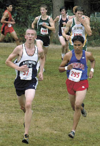 Arlington senior Sean Gregory digs deep for the final stretch of the varsity boys race.