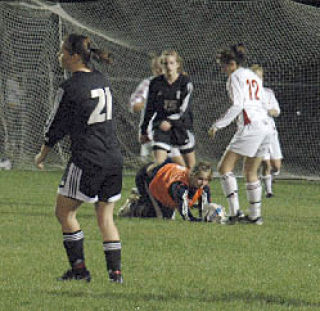 Sophomore goaltender Lauren Schoonover gets up from a harrowing save. Schoonover had dived to block the ball