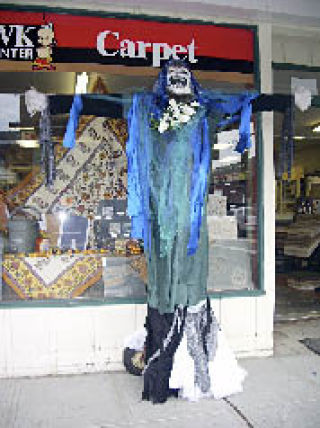 The scarecrow at Unique Interiors in downtown Arlington joins a cadre of scarecrows up and down Olympic Avenue in a contest coordinated by the Arlington Arts Council for the Fall season. The winners will be announced at the final Arlington Farmers Market  10 a.m.