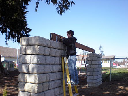 Lakewood High School senior Mitchel Gogert installs his “Hole in the Wall” senior project.