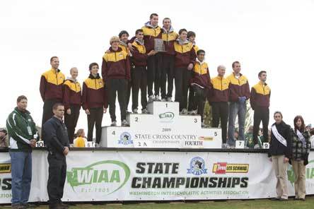 The Lakewood High School boys cross country team poses on the podium at the state meet after taking fourth place.