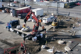 Two of Verena Schwippert’s large granite hand sculptures are off-loaded from a Cuz Concrete truck near the Everett Transit Center March 12.