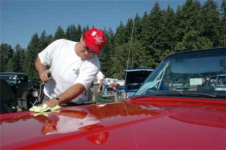 Yakima resident Danny Pellegrini cleans the hood of his 1964 Pontiac Bonneville convertible Sept. 12 at the Arlington Drag Strip Reunion and Car Show.